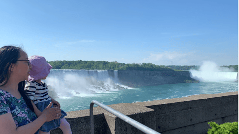 Woman holding child looking at Niagara Falls