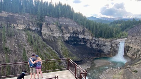 twopeople in front of a waterfalls