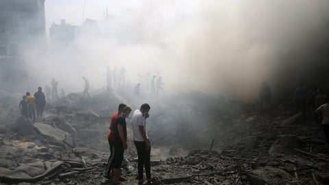 Palestinians look for survivors after an Israeli airstrike in Rafah refugee camp, southern Gaza Strip, on October 12 2023.