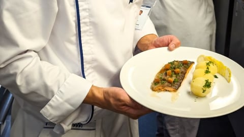 Chef-holding-plate-of-food