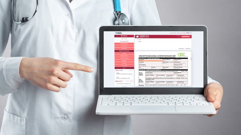 healthcare-provider-holding-laptop-with-OkRx-software