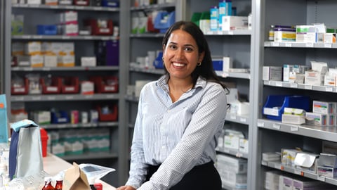 Southeast-Asian-woman-with-long-dark-hair-standing-in-pharmacy