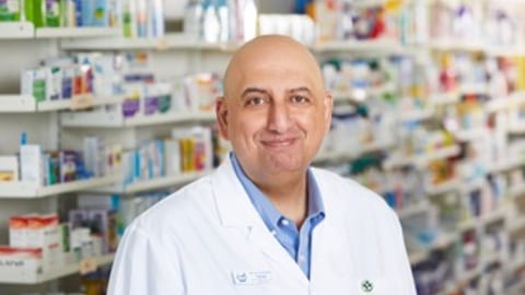 Pharmacy manager Tarek Hussein standing in his pharmacy