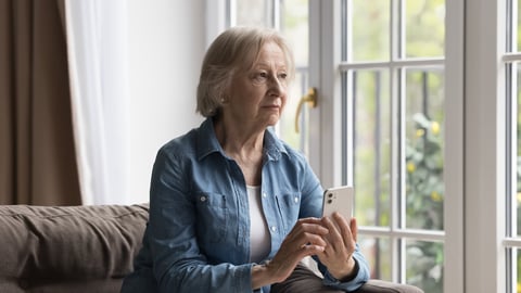 An older white woman using a cellphone to text