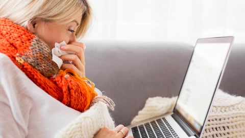 A sick woman using a computer