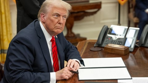 U.S. President Donald Trump signs executive orders on February 10, 2025.