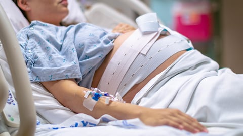 A woman in labour, giving birth in the hospital.
