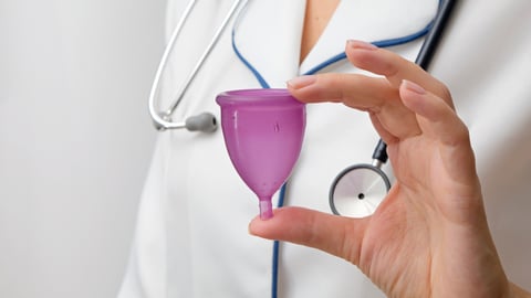Doctor showing menstrual cup