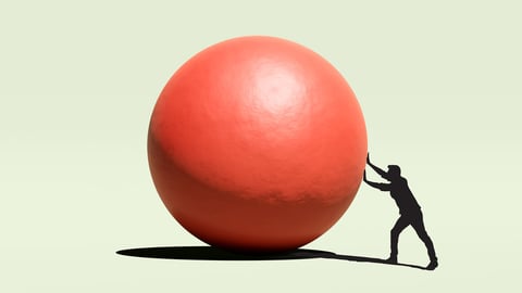Man pushing red ball 