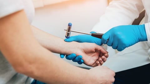 Family doctor examining older patients joints