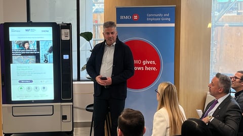 Dr. Sean B. Rourke presents an Our Healthbox machine. (REACH Nexus)