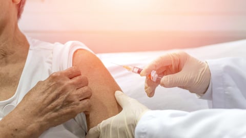 Older woman receiving a vaccine