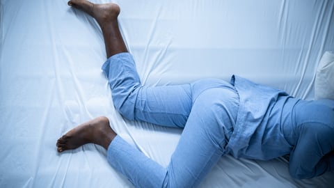 Legs in bed suggesting discomfort, movement, restless leg syndrome, rls