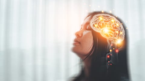 Young woman with a see-through image of her brain 