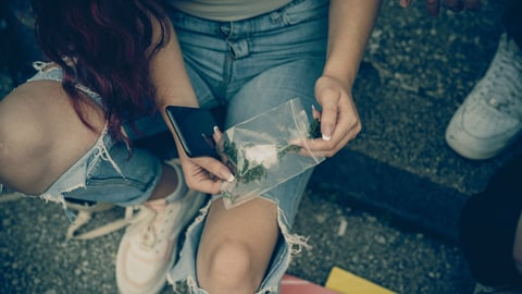 School teenagers consuming drugs, alcohol and tobacco on the school property while having fun and talking.