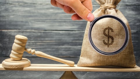 scale with judge's hammer and bag of money