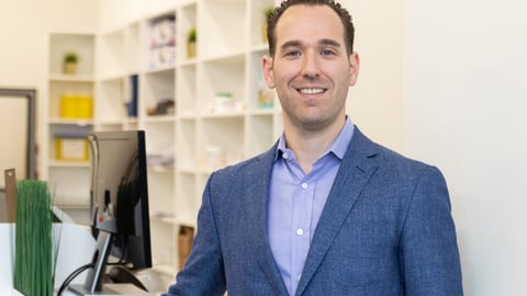 Adam Silvertown, owner of PACE Pharmacy and Vet Meds, in a blue suit in a pharmacy