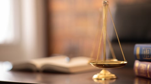 Scales of justice on a judge's desk.