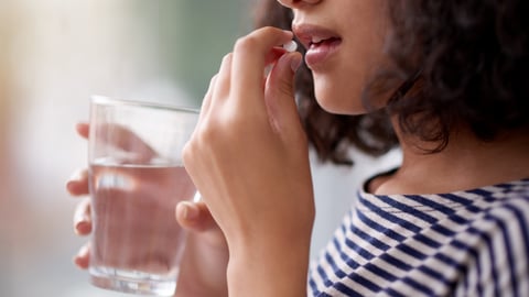 Woman taking a pill