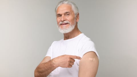 Older Caucasion white man flaunting his vaccinated arm