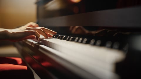 Fingers playing a piano