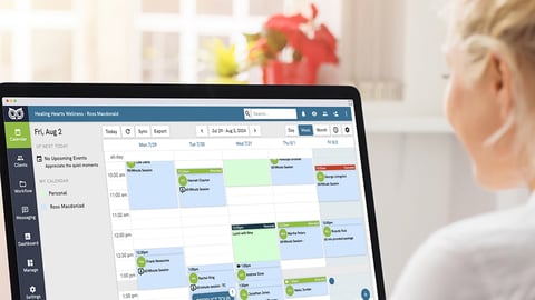Person viewing a digital schedule on desktop monitor.