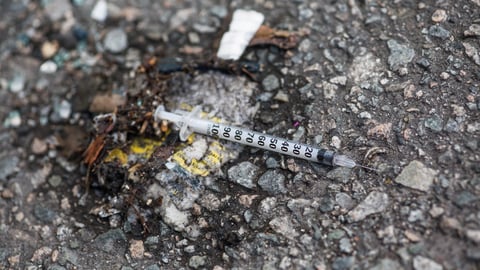A used empty needle syringe on the ground in Vancouver. 