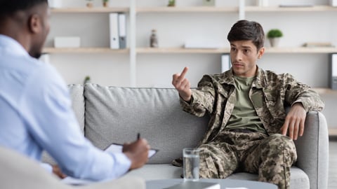 rude male white patient in khakis giving Black doctor the finger