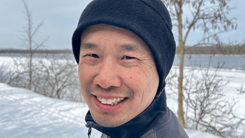 Smiling man on a walk outside during the winter