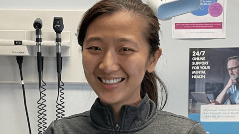 Dr. Han Yan smiling in a clinic for a photo