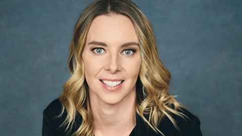 A blonde woman smiling for a photo