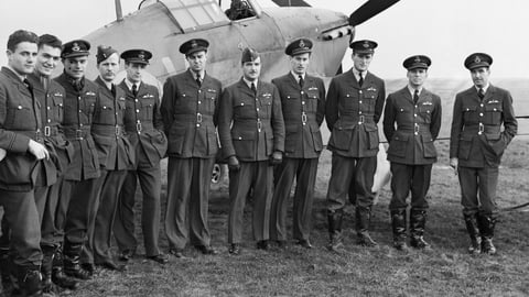 A row of WWII RCAF pilots stand in front of a Hawker Hurricaine airplane