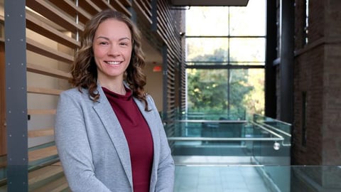Young woman doctor Jamaica Cass smiling for a photo in a grey jacket