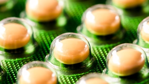 Yellow pills on a green blister pack