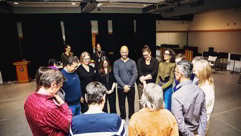 Theatre of Medicine participants gather in a circle during a workshop. (Peach Juice Creative)