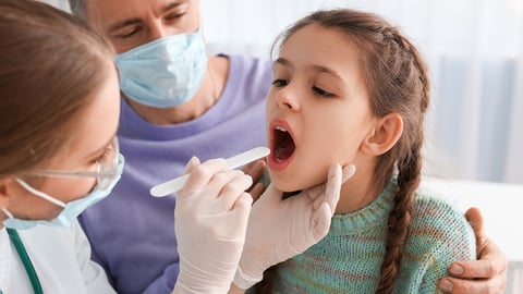 Young girl getting a throat swap checking for strep throat