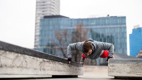 Older teenage boy doing intense pushup exercise