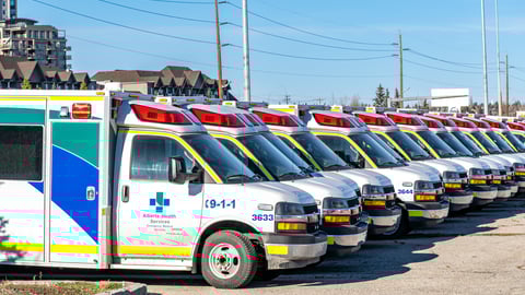 EMS ambulances parked in an Alberta Health Services parking lot in Calgary.