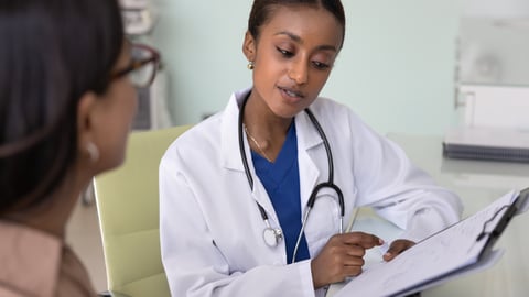 Young Black woman doctor chatting with a patient