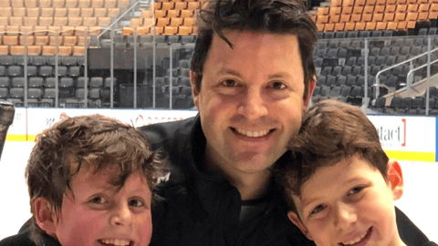 Dr. Efrem Mandelcorn hanging out with his two sons at an ice rink