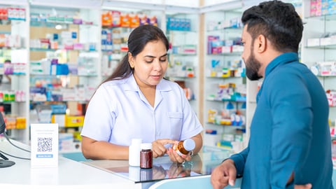 a pharmacy professional speaks with a patient