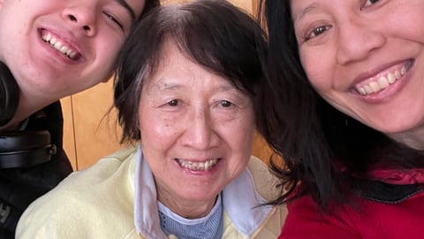 Dr. Melissa Yuan-Innes smiling with her family