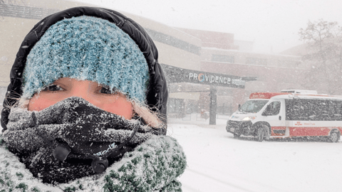 Julee Joseph in the snow in front of a pharmacy