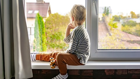 Young child looking out the window