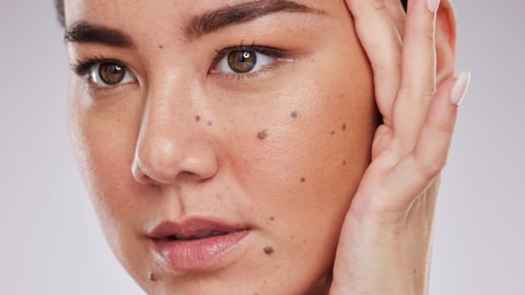 Young woman admiring herself in the mirror 