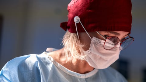 Surgeon with a red head covering