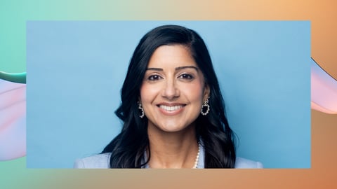 Shivali Sharma smiling with a blue background