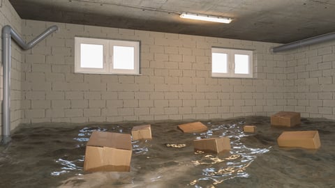 A flooded basement with boxes.