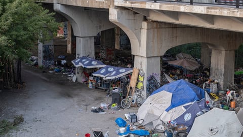 Homeless people encampment under a bridge in downtown Toronto.