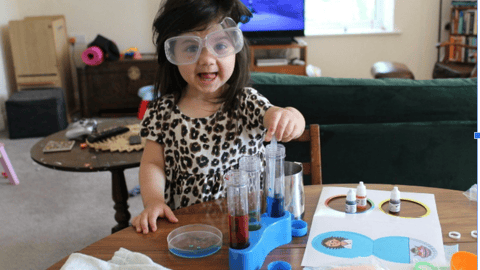 a little girl creating with paint